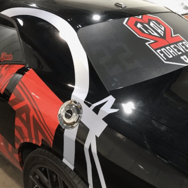 Car wrap being professionally installed for durability